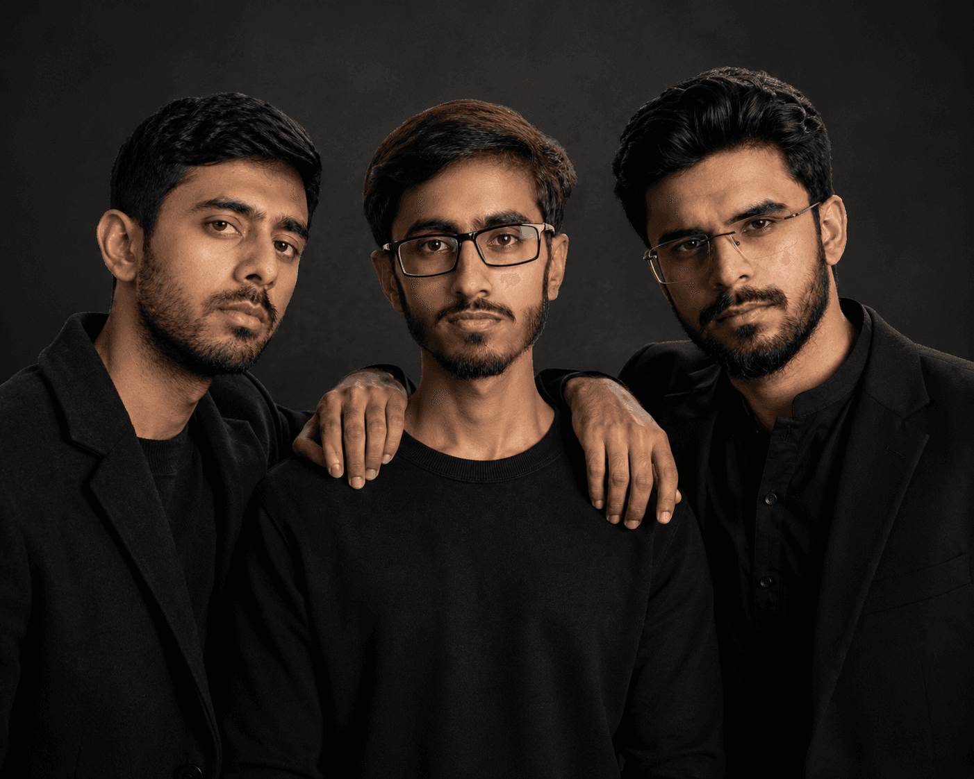 Three members of the Basefield Studio team photographed against a dark studio background